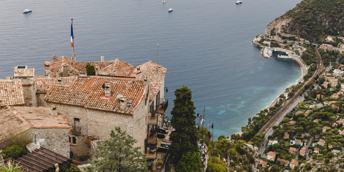 Aerial view of old city on hills by seashore on cloudy day, Eze, France